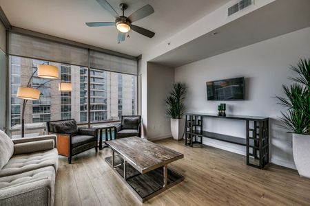 Furnished and decorated living area with Chene Oak Classic Swiss Kronos Wood Flooring, floor to ceiling windows and downtown views