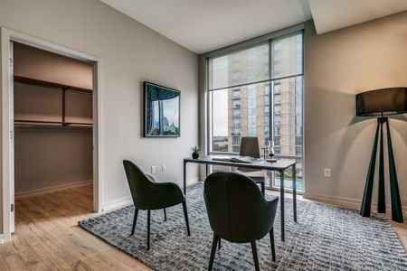 Furnished study with floor to ceiling windows next to walk in closet