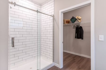 Primary bathroom with walk-in shower and walk-in closet
