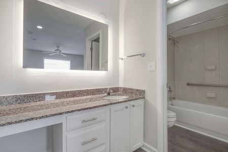unfurnished bathroom with counter and shower in apartment home