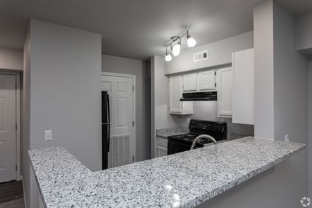 newly renovated kitchen with granite countertops and black appliances