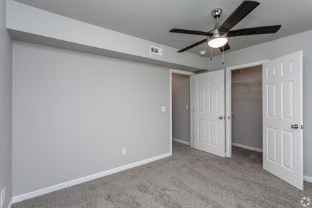 bedroom with carpet and neutral paint with closet