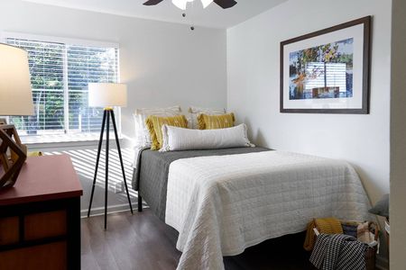 Private bedroom with mirrors on wall and desk at The Preserve at Tuscaloosa | Student Housing