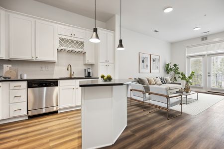 white and black modern kitchen and open living room at Lofts at Weston apartments