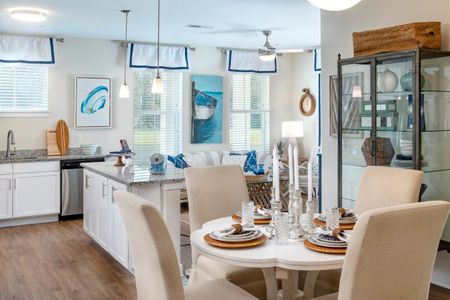 upclose of kitchen table with kitchen and living area in background