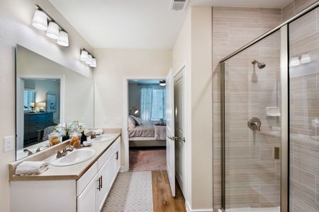 bathroom with glassdoors and double vanity sink