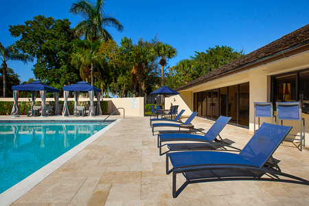 Pool with cabanas and lounge chairs