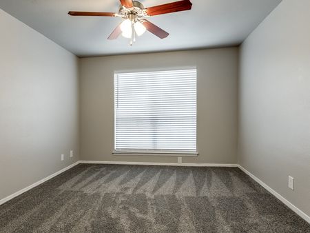 Bedroom with Ceiling Fan and Large Window