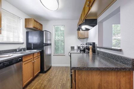 Fully Equipped Kitchen Featuring Hard-Surface Countertops and a Gleaming Suite of Appliances