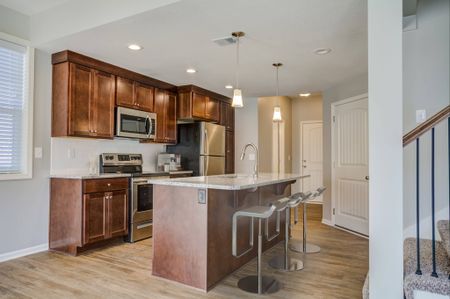 Lee's Summit Townhomes - Chapel Ridge Townhomes - Modern Kitchen with Stainless Steel Appliances and a Breakfast Bar