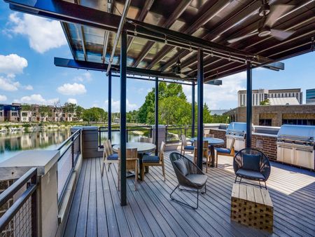 Outdoor grilling stations and resident covered lounge deck Lakeside community Midway Urban Village Luxury Townhomes and loft apartments in Farmers Branch, Texas near North Dallas. Luxury North Dallas Townhomes for rent