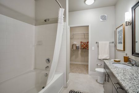 Spacious bathroom with granite countertops, garden bathub