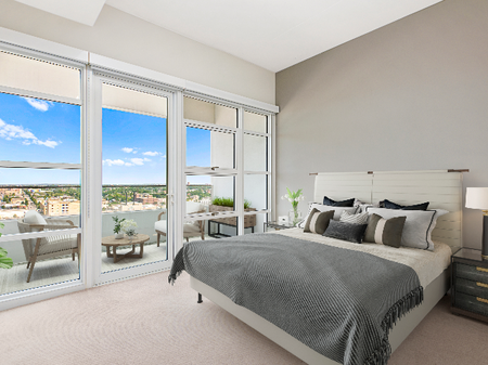 Two-Bedroom Apartments In Downtown Milwaukee, WI - The Moderne - Large Bedroom With Accent Wall, Bed, Nightstand, And Glass Wall With Exterior Door To Patio.