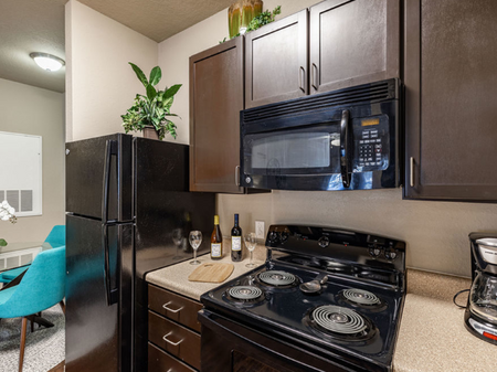 Big oaks apartments lakeland florida model kitchen with black appliances and wooden cabinets