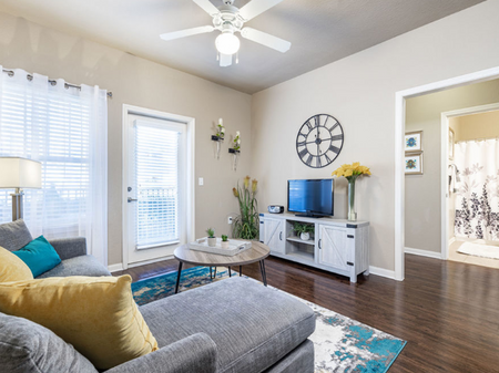 Big oaks apartments lakeland florida furnished model living room with ceiling fan, patio door