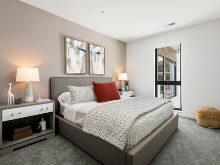 Bedroom at Parterre at Emerald Row with Stylish Decor Featuring Large Window