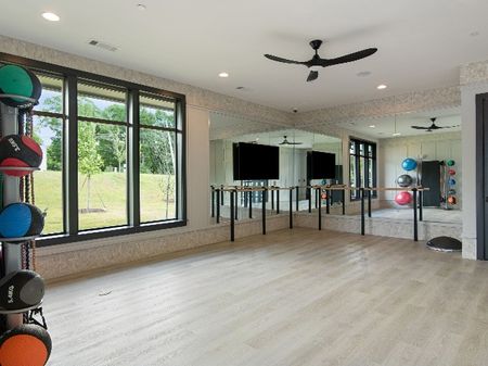 Large Yoga Studio with Mirrors, Wood Flooring, and Ample Natural Light.