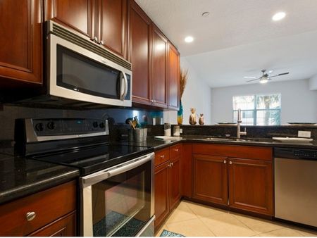 Kitchen with cabinets, sink, stainless steel oven, microwave, and dishwasher