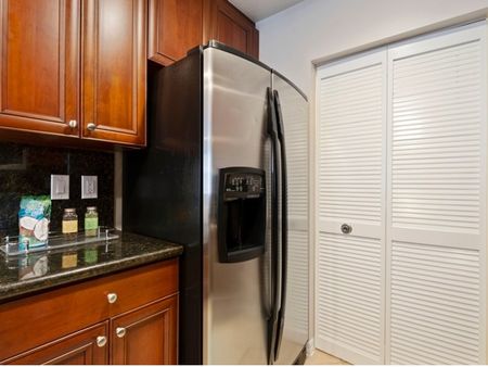 Kitchen with cabinets and stainless steel refrigerator