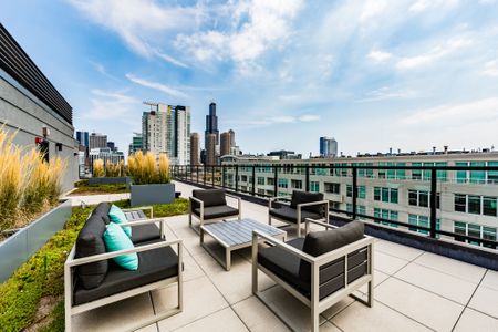 Rooftop lounge with comfortable patio seating and spectacular city views