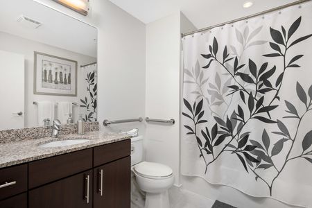 Downtown Milwaukee WI Apartments for Rent - The Moderne Bathroom with a Large Vanity, Stainless Steel Fixtures, and Shower
