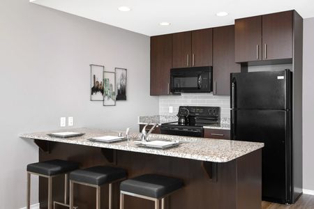 Apartments Downtown Milwaukee WI - The Moderne Fully Equipped Kitchen with Upgraded Countertops and Wooden Cabinetry