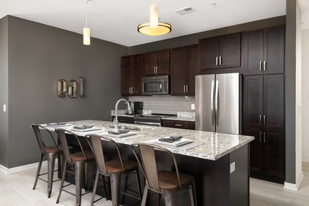 Emerald Row - Modern Kitchen With Stainless Steel Appliances, Granite Countertops, and Spacious Cabinets