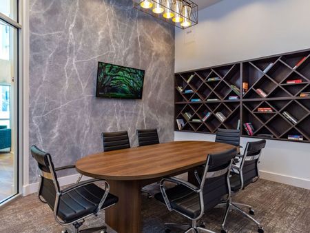 m2 at millenia conference room with large table, six chairs and a television