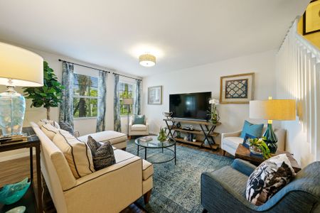 Living Room with couch, three chairs, coffee table, television and t.v. stand