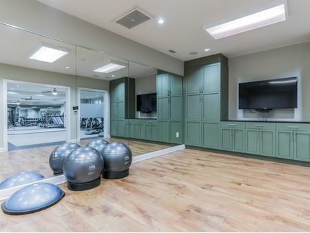 Floor space, exercise balls, mirrors in fitness center  | The Rocca Apartments in Atlanta, GA