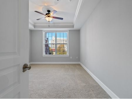 Carpeted bedroom with ceiling fan  | The Rocca Apartments in Atlanta, GA