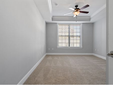 Bedroom with ceiling fan and large windows  | The Rocca Apartments in Atlanta, GA