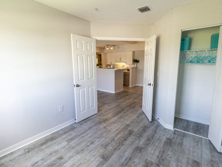 Large 2nd bedroom with light wood flooring