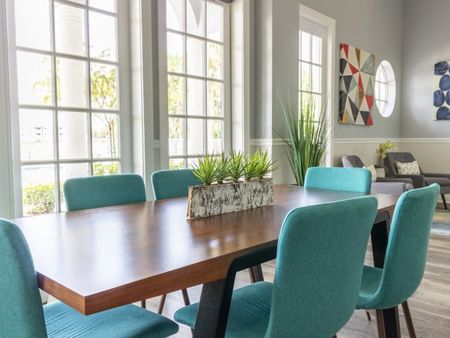 Beautiful 6 seat turquoise and wood conference table located in the clubhouse.