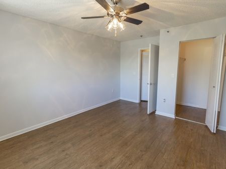 Bedroom with wood flooring and ceiling fan