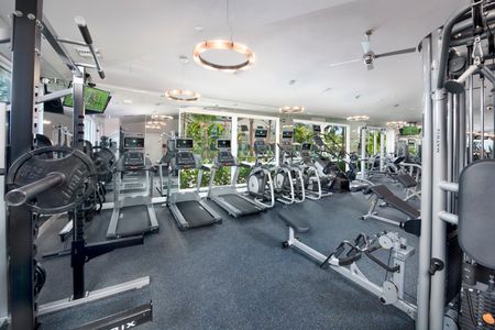 Fitness center with mirror wall, treadmills, elliptical machines, stair machine and strength training machines