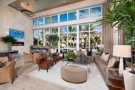 Indoor lounge seating with couches, chairs and TV. View of pool area with large open windows