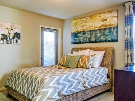 Dog-Friendly Apartments in Hermitage - Highlands at the Lake - Fully Furnished Bedroom with Carpet Flooring, Glass Door to the Outside, and Stylish Decor