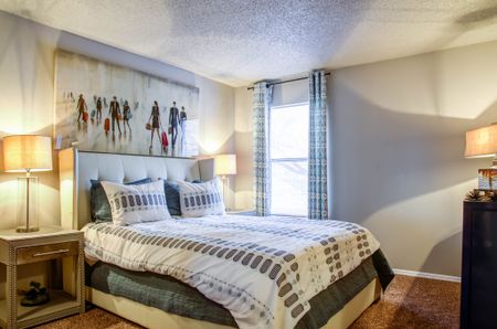 Apartments For Rent In Bellevue, TN - Roomy Bedroom With Carpet Flooring And A Window.