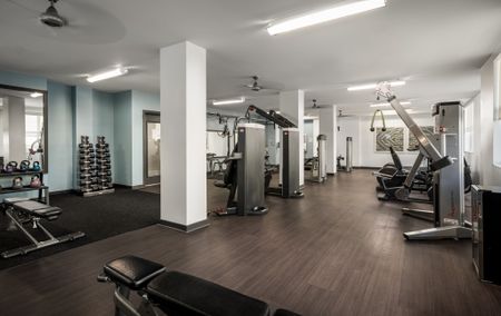 Fitness center with treadmills, workout benches, and various weight machines