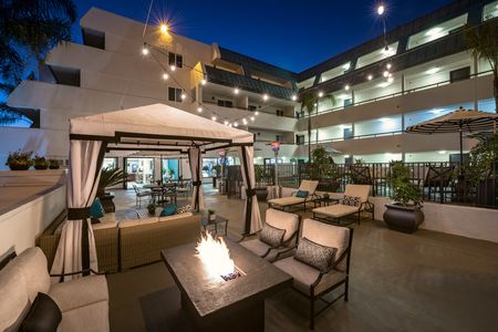 pool deck with cabanas and outdoor fireplace at the warwick