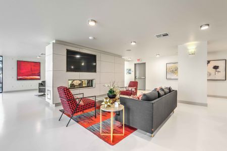 resident lounge with sofa and chairs and tv at arte apartments