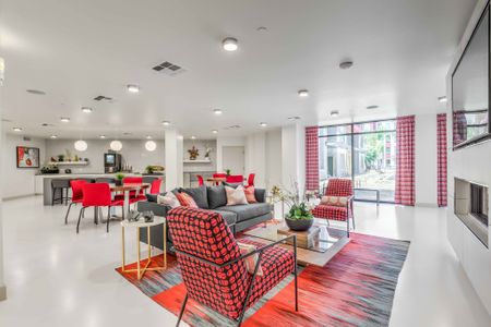 resident lounge with white flooring and red accents and red chairs