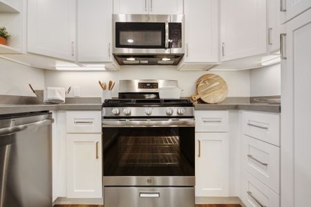 Kitchen with upscale stainless steel appliances and quartz countertops