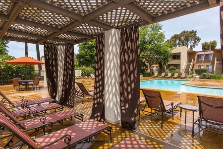 community pool and lounge area with cabanas