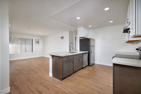 updated living room with renovated kitchen with breakfast bar