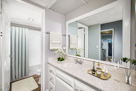 virtually staged bathroom with updated cabinets and countertops