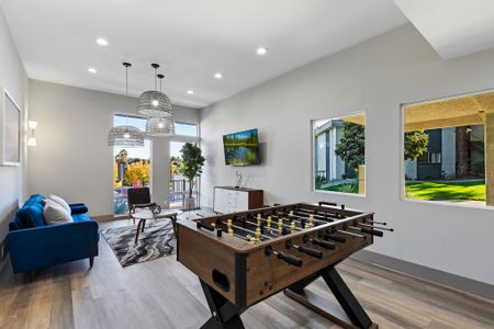 community clubhouse with foosball table, seating and TV