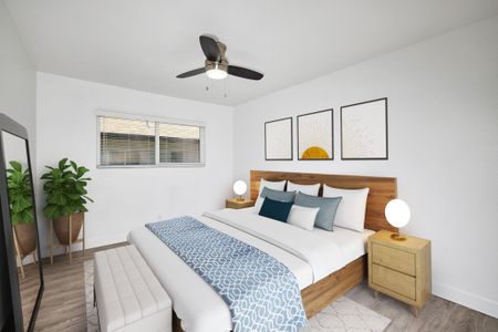 Virtually Staged Updated bedroom with sustainable carpets, ceiling fan and two windows with window coverings