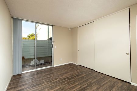 Large room with large sliding glass doors leading out to patio